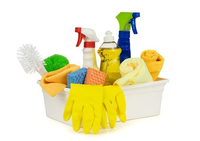 Various household cleaning supplies in a box. Pure white background, soft shadows.